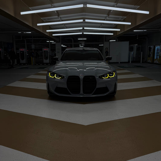 Car with glowing headlights in a dark garage